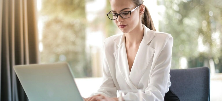 Professional auto insurance broker working on a laptop