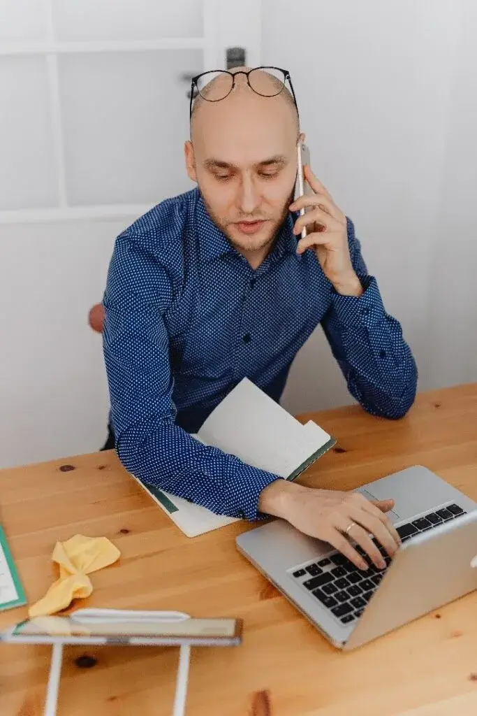 A man talking on the phone to a Kemper Insurance Agent